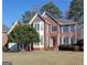 Two-story home with a red door and attached garage at 3239 Talimore Cir, Marietta, GA 30066