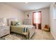 Bright bedroom with a twin bed, dresser, and window at 205 Weldon Rd # 44, Mcdonough, GA 30253