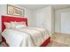 Bedroom with red upholstered bed and carpet flooring at 205 Weldon Rd # 44, Mcdonough, GA 30253