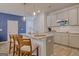 Modern kitchen with an island, granite countertops, stainless steel appliances, and gray cabinets at 205 Weldon Rd # 44, Mcdonough, GA 30253