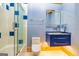 Modern bathroom with blue vanity and walk-in shower at 242 Kirkley Rd, Tyrone, GA 30290