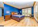 Blue bedroom with hardwood floors and large windows at 242 Kirkley Rd, Tyrone, GA 30290