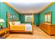 Guest bedroom with wood floors and teal walls at 242 Kirkley Rd, Tyrone, GA 30290