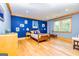Bright bedroom with hardwood floors and blue walls at 242 Kirkley Rd, Tyrone, GA 30290