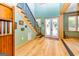 Bright entryway with hardwood floors, a staircase, and double doors at 242 Kirkley Rd, Tyrone, GA 30290