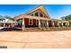 Red house exterior with a wraparound porch and a large front yard at 242 Kirkley Rd, Tyrone, GA 30290
