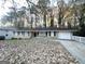 House exterior showcasing a ranch-style home with a driveway and mature trees at 2798 Engle Nw Rd, Atlanta, GA 30318
