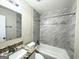 Bathroom with granite vanity, marble tile shower/tub combo, and mirror at 3568 Glenview Cir, Atlanta, GA 30331