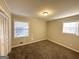 Bright bedroom with neutral walls, carpet flooring, and two windows at 3568 Glenview Cir, Atlanta, GA 30331