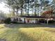Brick ranch house with a red door, carport, and spacious yard at 3568 Glenview Cir, Atlanta, GA 30331