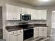 Modern kitchen with granite countertops and stainless steel appliances at 110 Clover Valley Dr, Covington, GA 30016