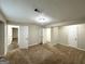 Large basement bedroom with carpet, multiple doors, and closets at 2852 Port Royal Ln, Decatur, GA 30034