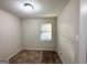 Cozy bedroom with neutral walls, carpet flooring, and a window at 2852 Port Royal Ln, Decatur, GA 30034