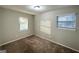 Bright bedroom featuring neutral walls, carpet, and two windows at 2852 Port Royal Ln, Decatur, GA 30034