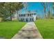 Two-story house with gray siding, a grassy lawn, and a paved driveway at 2852 Port Royal Ln, Decatur, GA 30034
