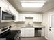 Updated kitchen featuring white cabinets, granite countertops, and stainless steel appliances at 2852 Port Royal Ln, Decatur, GA 30034