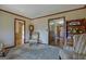 Living room with carpeted floors, various armchairs, and access to another room at 320 Bates Ave, Fayetteville, GA 30215