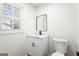 Modern bathroom with white vanity, quartz countertop, and black fixtures at 6864 Fielder Rd, Rex, GA 30273
