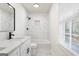 Updated bathroom with marble tile, bathtub, and modern vanity at 6864 Fielder Rd, Rex, GA 30273