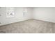 Well-lit bedroom with neutral walls and carpet at 6864 Fielder Rd, Rex, GA 30273
