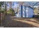 Side view of a blue house with fenced backyard at 6864 Fielder Rd, Rex, GA 30273
