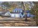 Two-story blue house with a two car garage and landscaped yard at 6864 Fielder Rd, Rex, GA 30273
