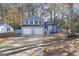 Cute blue house with a two-car garage and a spacious yard at 6864 Fielder Rd, Rex, GA 30273