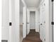 Clean hallway with dark wood floors and closet at 6864 Fielder Rd, Rex, GA 30273