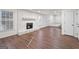Living room with a stone fireplace and hardwood floors at 6864 Fielder Rd, Rex, GA 30273