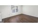 Bright office space with dark wood flooring and window at 6864 Fielder Rd, Rex, GA 30273