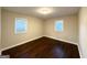 Spacious bedroom with dark hardwood floors and two windows at 2030 Fargo Se Pl, Atlanta, GA 30316