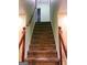 Staircase with wooden railing and carpeted steps at 1034 Bettina Sw Ct, Mableton, GA 30126