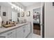 Bathroom with granite countertop, white cabinets, and view of bedroom at 6324 Amberly Rd, Rex, GA 30273