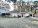 Gray sided ranch home with red front door and mature landscaping at 2312 Leslie Brook Dr, Decatur, GA 30035
