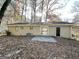 Back view of the home showcasing a patio and wooded backyard at 4448 Malibu Dr, Decatur, GA 30035