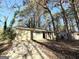 Ranch home nestled among mature trees, featuring a long driveway at 4448 Malibu Dr, Decatur, GA 30035