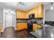 Modern kitchen with dark countertops and wood cabinets at 409 Bellway Ct, Tyrone, GA 30290