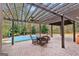 Covered patio with ceiling fan, overlooking the pool and backyard at 409 Bellway Ct, Tyrone, GA 30290