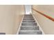 Gray carpeted staircase with wooden handrail at 4335 Burgomeister Pl, Snellville, GA 30039