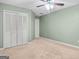 Bright bedroom with ceiling fan and double door closet at 270 Jeff Davis Pl, Fayetteville, GA 30214