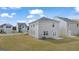 Rear view of house, showcasing patio and yard at 11879 Aukerman Way # 128, Hampton, GA 30228