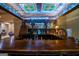 Custom-built bar with a stained-glass ceiling and extensive liquor shelving at 320 Massengale Rd, Brooks, GA 30205