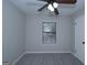 Bedroom with window, ceiling fan, and gray carpet at 321 Summerwood Ln, Stockbridge, GA 30281