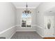 Dining area with a chandelier and arched window at 75 Heatherstone Way, Covington, GA 30016