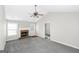 Spacious living room featuring a fireplace and ceiling fan at 75 Heatherstone Way, Covington, GA 30016