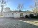 Brick home's backyard features a patio and spacious lawn at 3438 Maryvale Dr, Decatur, GA 30032