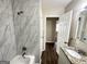 Renovated bathroom with marble tile and new fixtures at 3438 Maryvale Dr, Decatur, GA 30032
