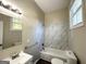 Updated bathroom with a bathtub, vanity, and marble tile at 3438 Maryvale Dr, Decatur, GA 30032