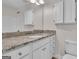 Bathroom with granite countertop vanity, white cabinets, and shower/tub combo at 102 Lancers Loft, Peachtree City, GA 30269