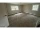 Spacious carpeted bedroom with neutral walls and two windows at 45 North Ave, Hampton, GA 30228